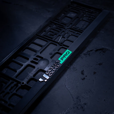 ULTRACOAT PRO licence plate frame on a dark background