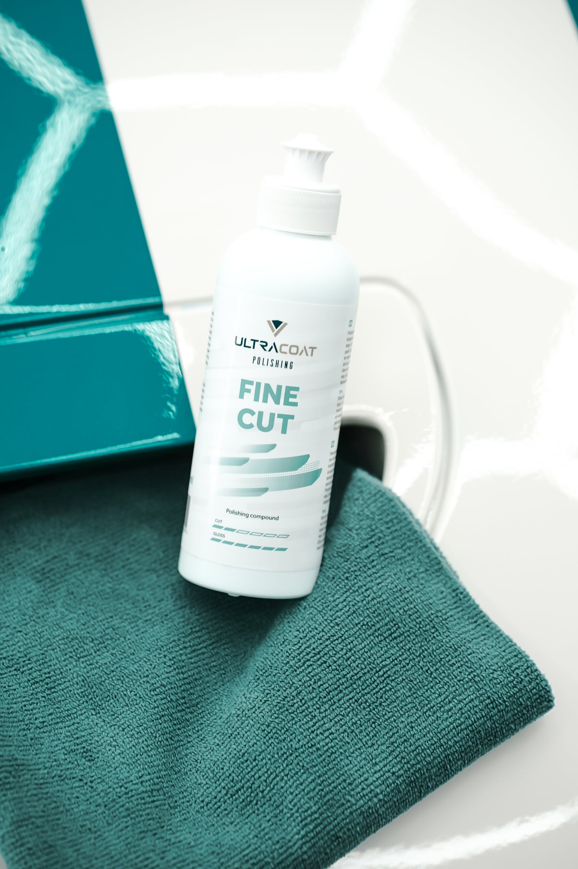 ULTRACOAT Fine Cut polishing compound beside automotive paint
