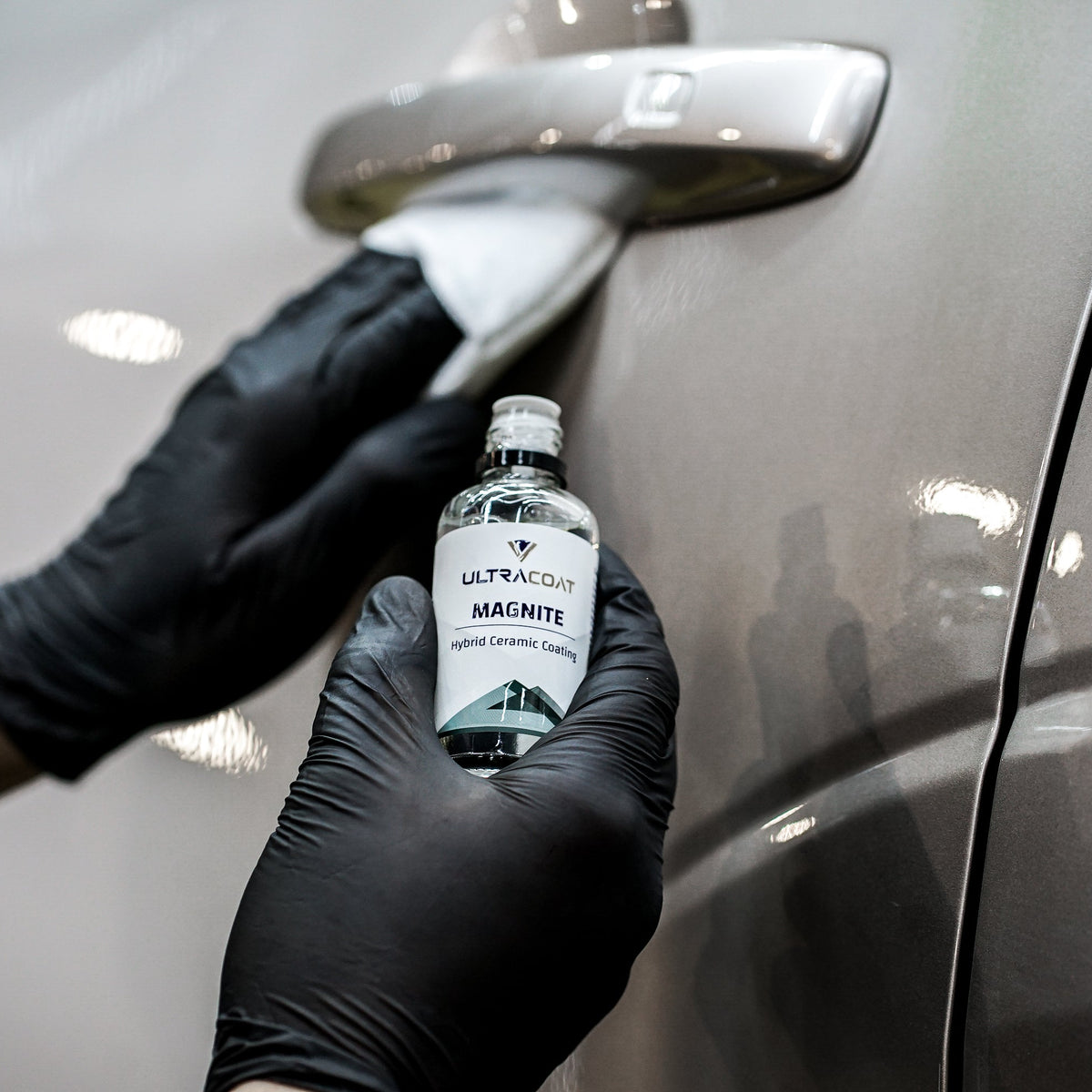 ULTRACOAT Magnite bottle with an applicator on automotive paint